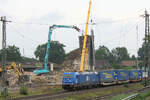 185 303-5 EGP durchf�hrt mit einen 'LKW-Walter' Tostedt. Im Hintergrund: Abrissarbeiten am Vormittag des 19.08.2026.